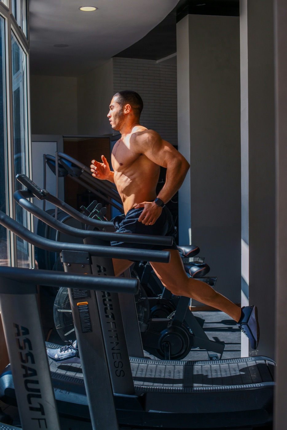Member running on a treadmill in natural light — photo by Sour Moha on Unsplash